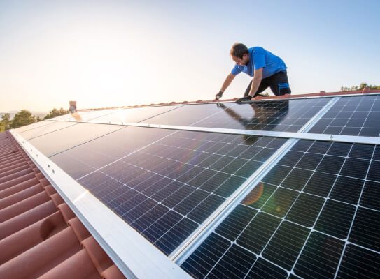 Image of man working on solar panels
